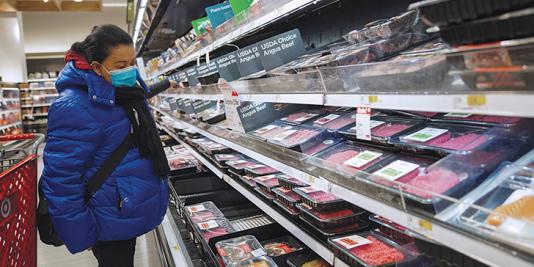 Woman shopper looking at food prices