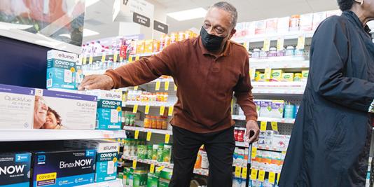 Senior man reaches for COVID-19 test